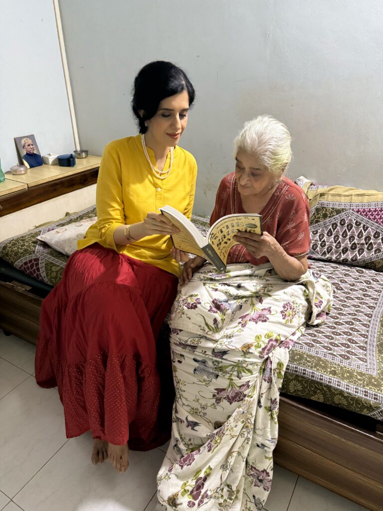 Anushruti showing her book The Sattvic Way to her grandmother