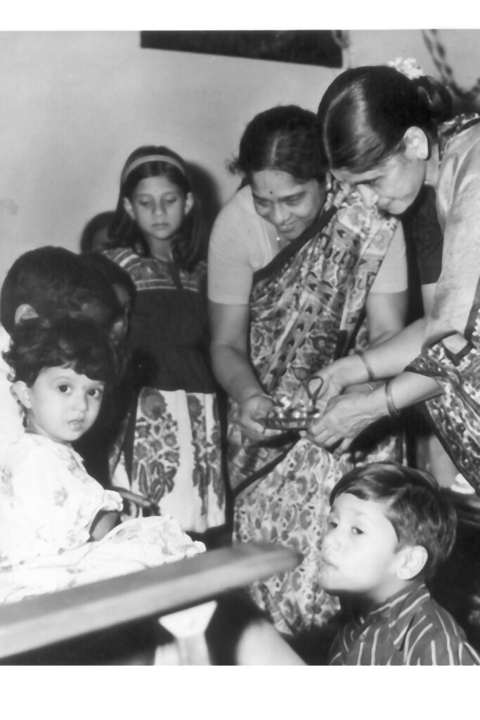 Grandmothers performing arati for Anushruti
